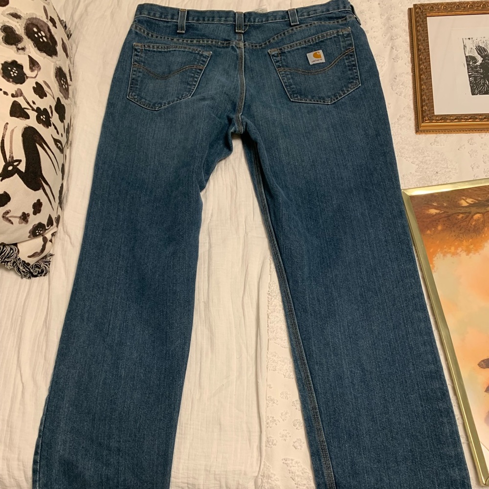 Carhartt blue, denim jeans, size 38x32 with gold stitching.